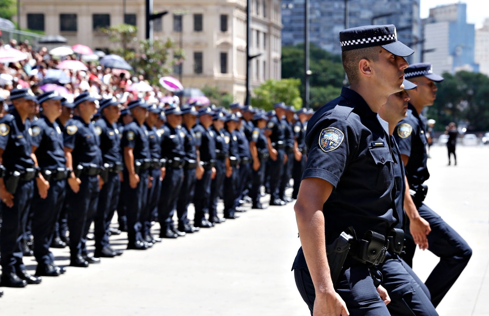 Agentes da Guarda Civil Metropolitana uniformizados e perfilados durante cerimônia de formatura