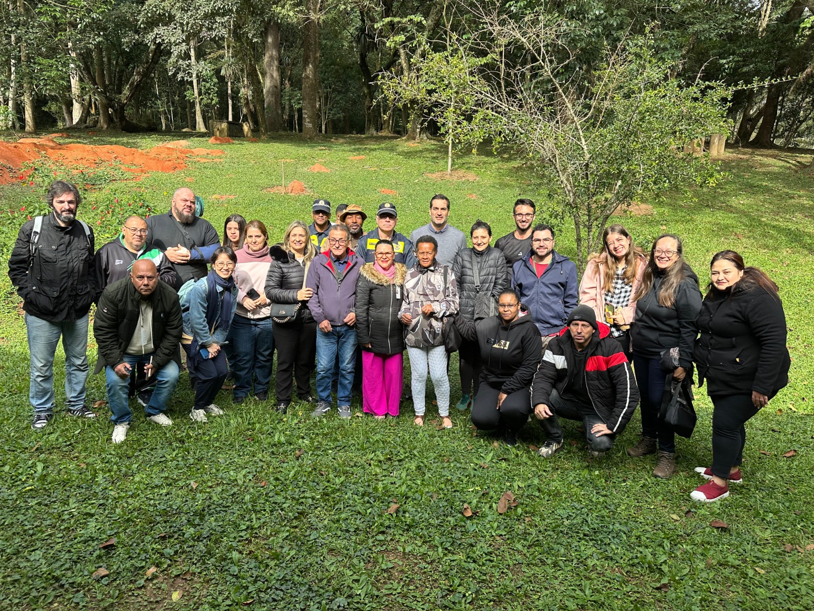 Imagem de pessoas posando em área verde do Parque do Carmo